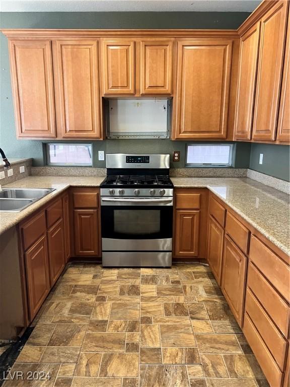 kitchen with stainless steel gas range oven and sink