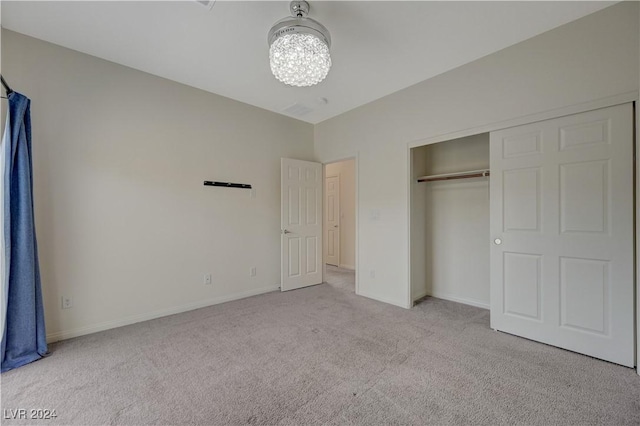 unfurnished bedroom featuring a closet and light colored carpet