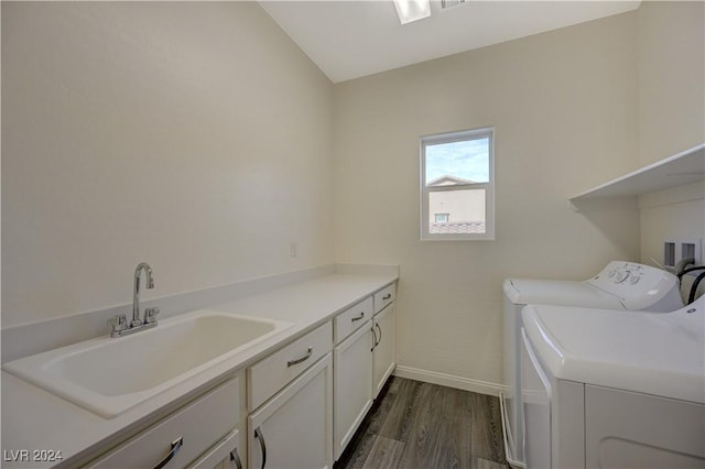 washroom with cabinets, independent washer and dryer, dark wood-type flooring, and sink