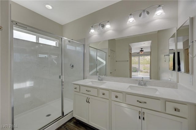 bathroom with an enclosed shower, hardwood / wood-style floors, vanity, and ceiling fan