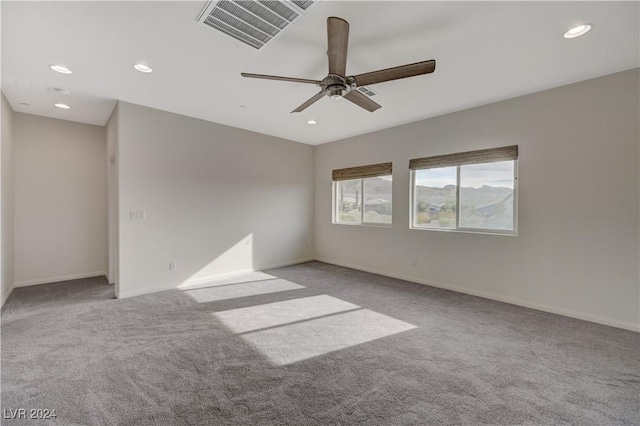 carpeted empty room featuring ceiling fan