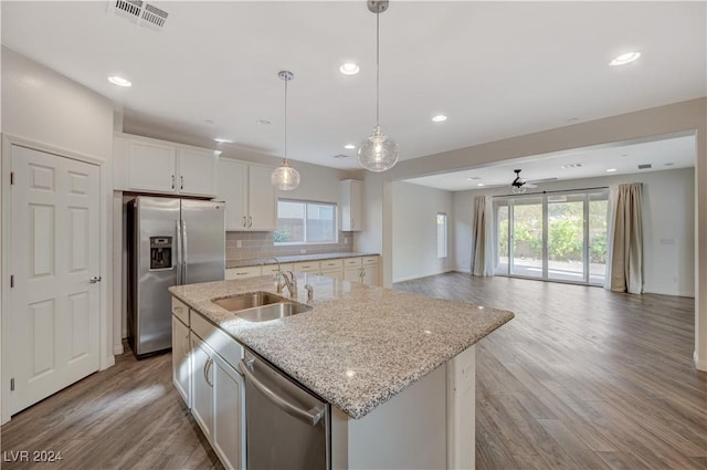 kitchen featuring sink, white cabinetry, stainless steel appliances, and an island with sink