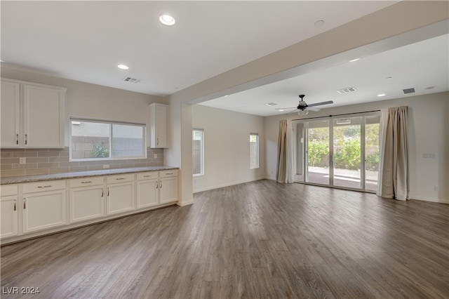 unfurnished living room with hardwood / wood-style flooring and ceiling fan