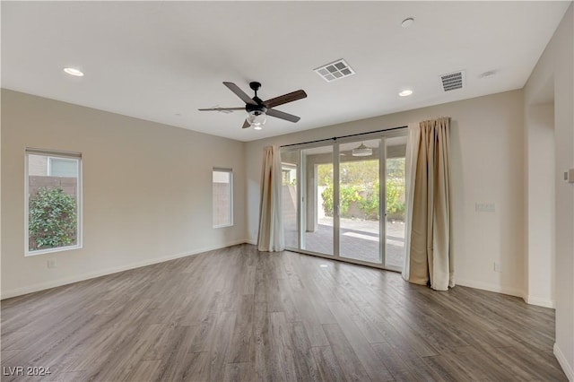 unfurnished room with ceiling fan and hardwood / wood-style flooring