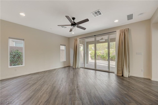 empty room with hardwood / wood-style floors and ceiling fan