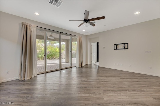 spare room featuring hardwood / wood-style floors and ceiling fan