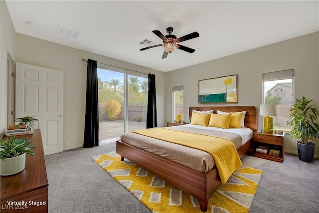 carpeted bedroom featuring ceiling fan, access to exterior, and multiple windows