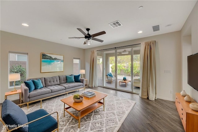 living room featuring dark hardwood / wood-style flooring and ceiling fan