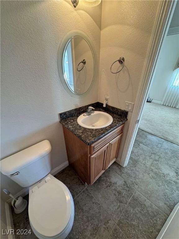 bathroom featuring tile patterned floors, vanity, and toilet