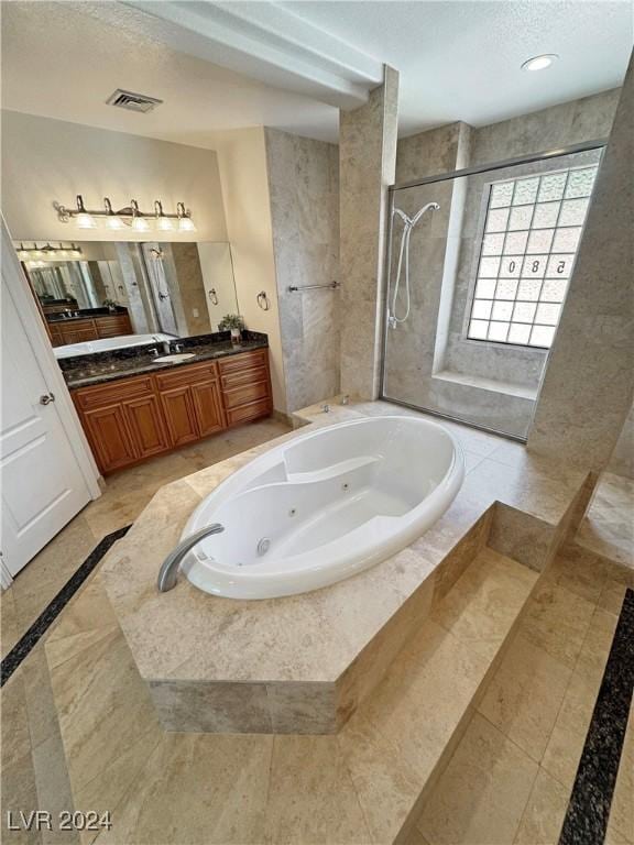 bathroom featuring vanity and separate shower and tub