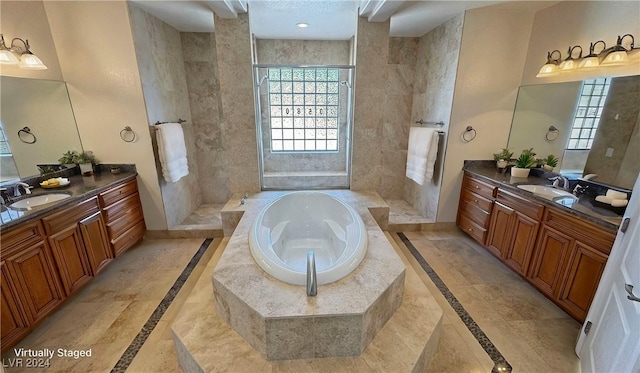 bathroom featuring tile patterned floors, plus walk in shower, and vanity