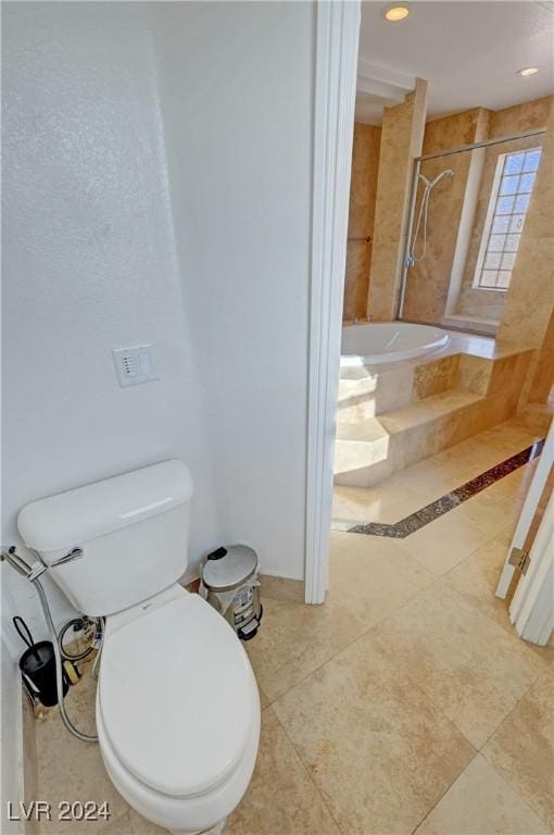 bathroom featuring tile patterned flooring, independent shower and bath, and toilet