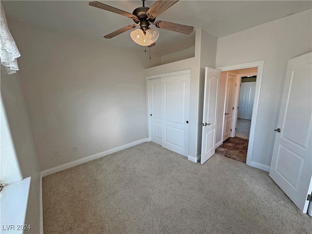 unfurnished bedroom with ceiling fan, a closet, and light colored carpet