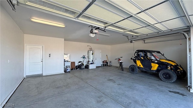 garage featuring strapped water heater and a garage door opener