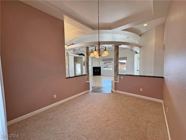 carpeted empty room featuring a notable chandelier, beam ceiling, and a textured ceiling