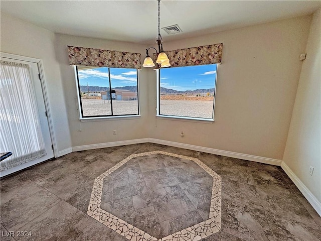 unfurnished dining area with a chandelier