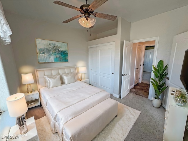 carpeted bedroom featuring ceiling fan and a closet