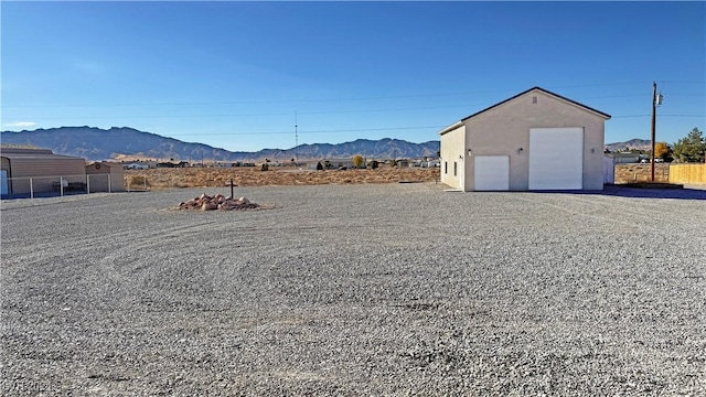 view of yard featuring a mountain view and a garage