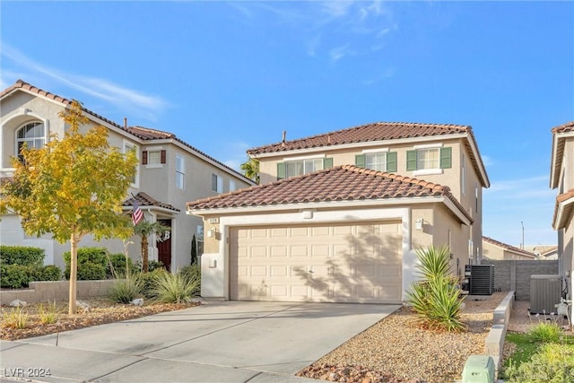 mediterranean / spanish-style house with central AC and a garage