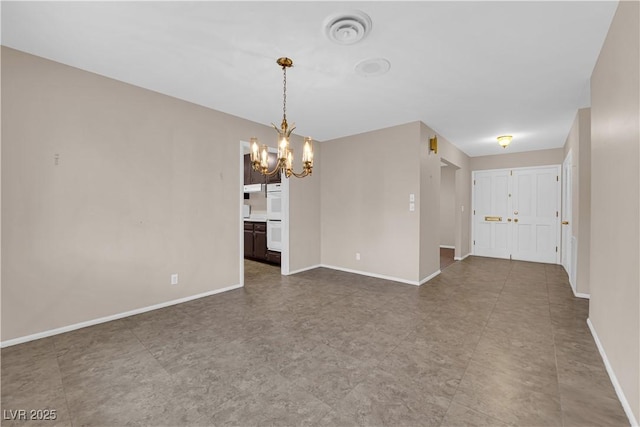 interior space with baseboards and a chandelier