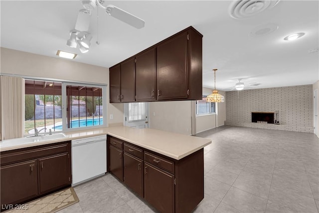 kitchen featuring a ceiling fan, open floor plan, light countertops, dark brown cabinets, and dishwasher