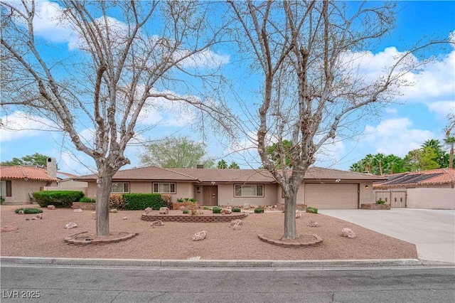 single story home featuring stucco siding, concrete driveway, and an attached garage