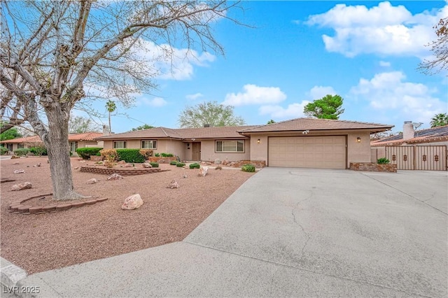 ranch-style home featuring stucco siding, driveway, and an attached garage