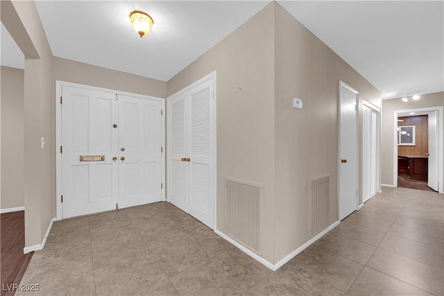 entrance foyer with visible vents, baseboards, and tile patterned flooring