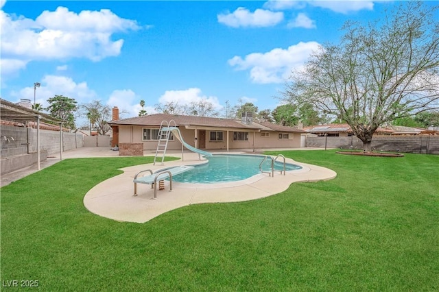 view of pool featuring a fenced backyard, a lawn, a water slide, and a patio