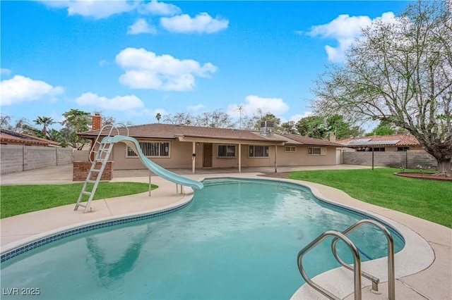 view of pool with a fenced in pool, a water slide, a lawn, a fenced backyard, and a patio