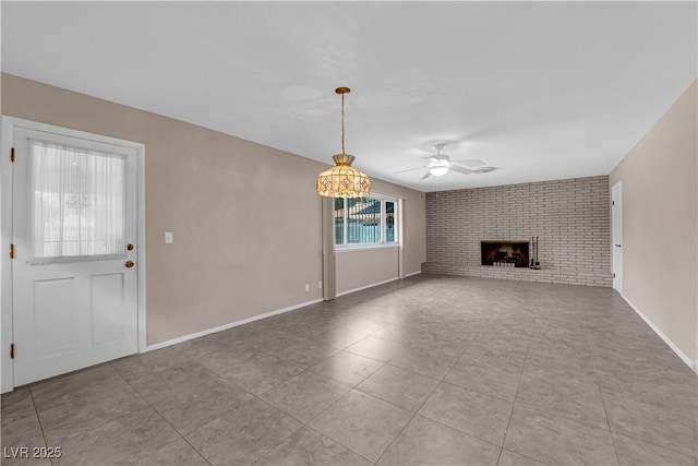 unfurnished living room with tile patterned flooring, a fireplace, baseboards, and ceiling fan