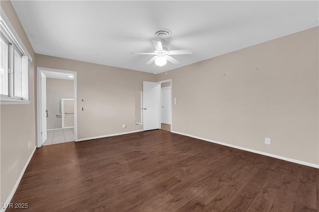 unfurnished room with wood finished floors, baseboards, and ceiling fan