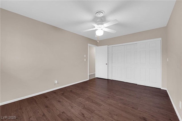 unfurnished bedroom featuring a closet, ceiling fan, baseboards, and wood finished floors