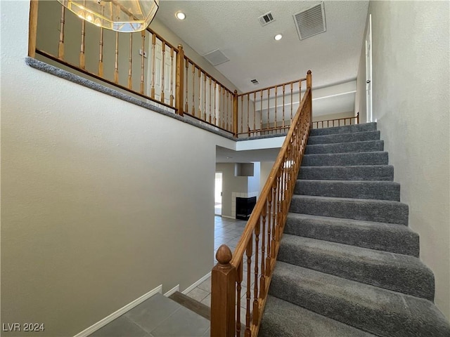 staircase featuring tile patterned floors