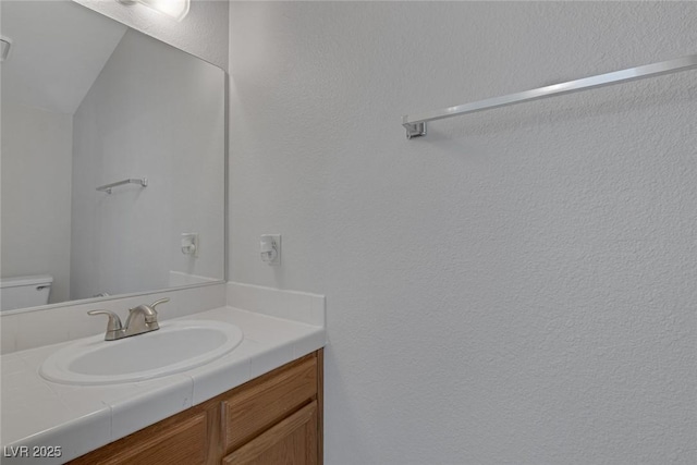 bathroom with vanity and toilet