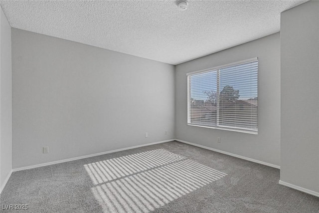 empty room featuring a textured ceiling and carpet