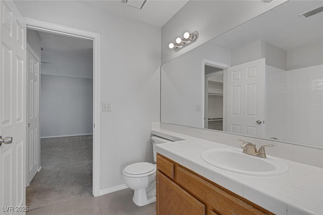 bathroom with tile patterned floors, vanity, and toilet