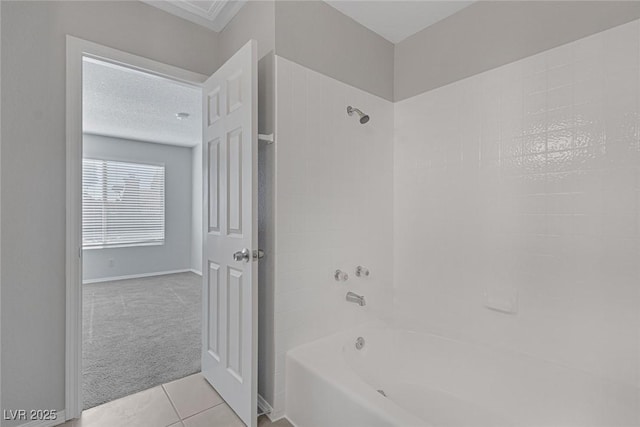 bathroom with bathtub / shower combination, tile patterned flooring, and a textured ceiling