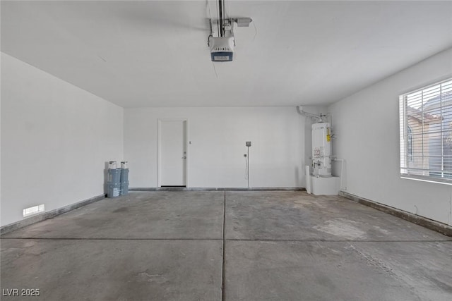 garage with strapped water heater and a garage door opener