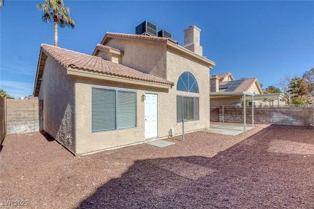 rear view of house featuring central AC and a patio