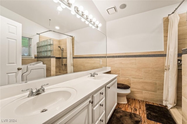 bathroom with vaulted ceiling, hardwood / wood-style flooring, a shower with shower curtain, toilet, and tile walls