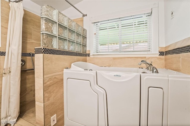 washroom featuring tile walls