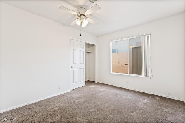 unfurnished bedroom featuring ceiling fan, carpet floors, and a closet