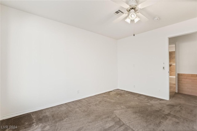 empty room featuring carpet floors and ceiling fan