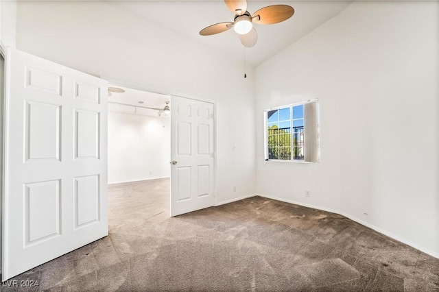 unfurnished bedroom with ceiling fan, carpet floors, high vaulted ceiling, and a closet