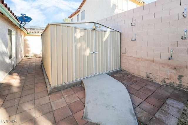 view of patio with a shed