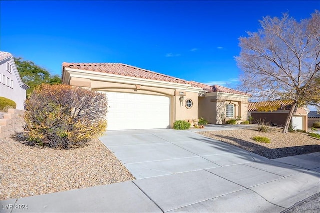 mediterranean / spanish-style home with a garage