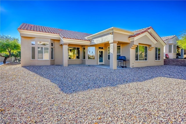 back of house with a patio