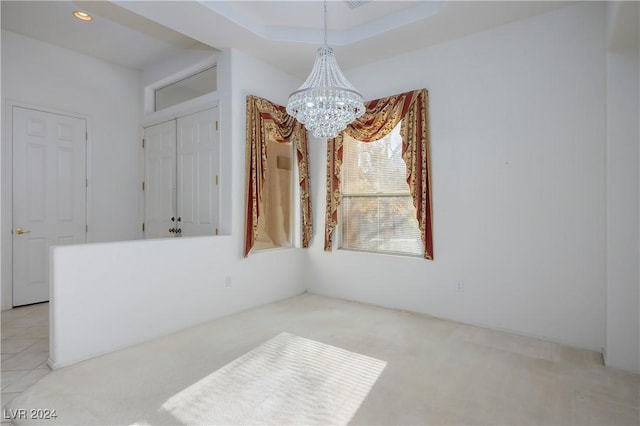 carpeted dining room featuring an inviting chandelier