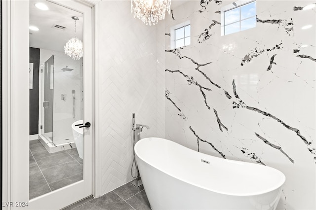 bathroom featuring shower with separate bathtub, tile patterned floors, tile walls, and a notable chandelier